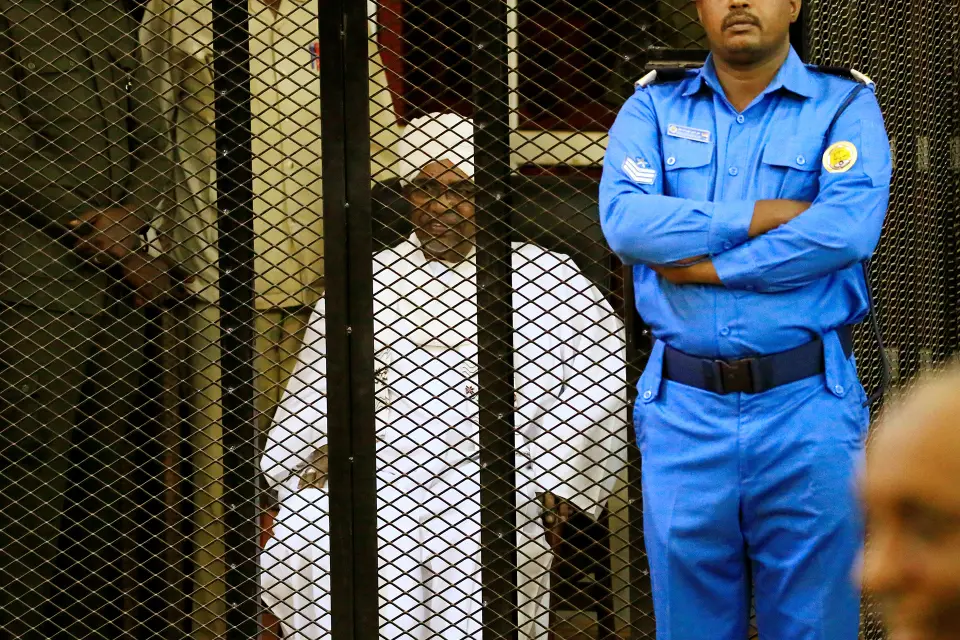 Sudanese former president Omar Hassan al-Bashir sits inside a cage during the hearing of the verdict that convicted him of corruption charges in a court in Khartoum, Sudan. December 14, 2019. REUTERS/Mohamed Nureldin Abdallah